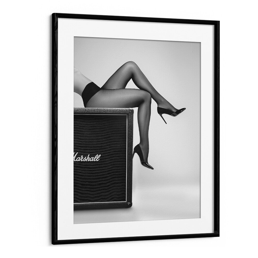 Stylish legs in black stockings resting on an amplifier, showcasing ROCK N LEGS, PHOTOGRAPHY PRINTS by David Drake.