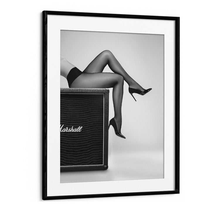Stylish legs in black stockings resting on an amplifier, showcasing ROCK N LEGS, PHOTOGRAPHY PRINTS by David Drake.