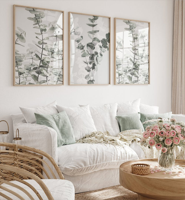 Stylish living room featuring the TRANQUIL EUCALYPTUS SET, SET OF 3 PAINTINGS, enhancing natural serenity at home.