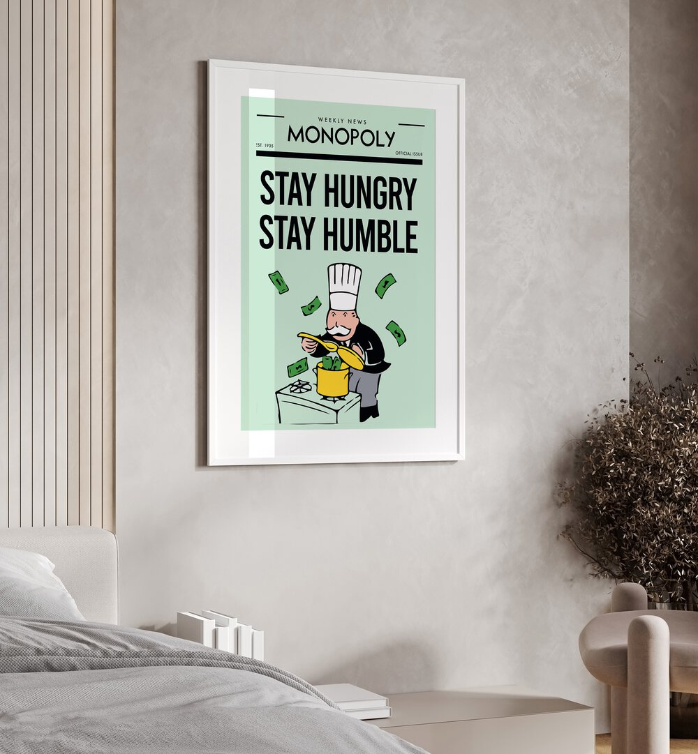 Stay Hungry Stay Humble Money Art Artwork in white frame with mount hanging on wall in bedroom