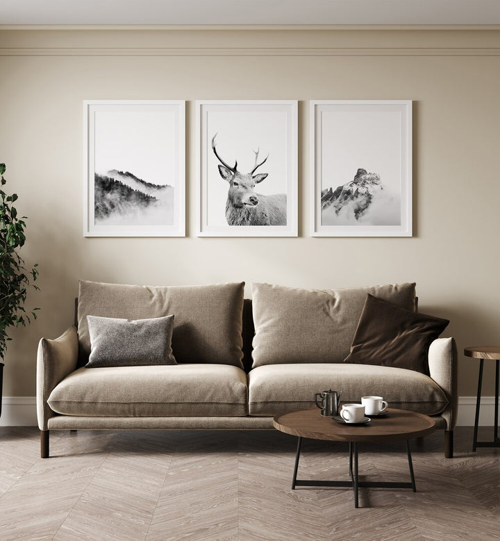 Elegant living room featuring the SNOW FOREST, SET OF 3 PAINTINGS, showcasing majestic reindeer in winter landscapes.