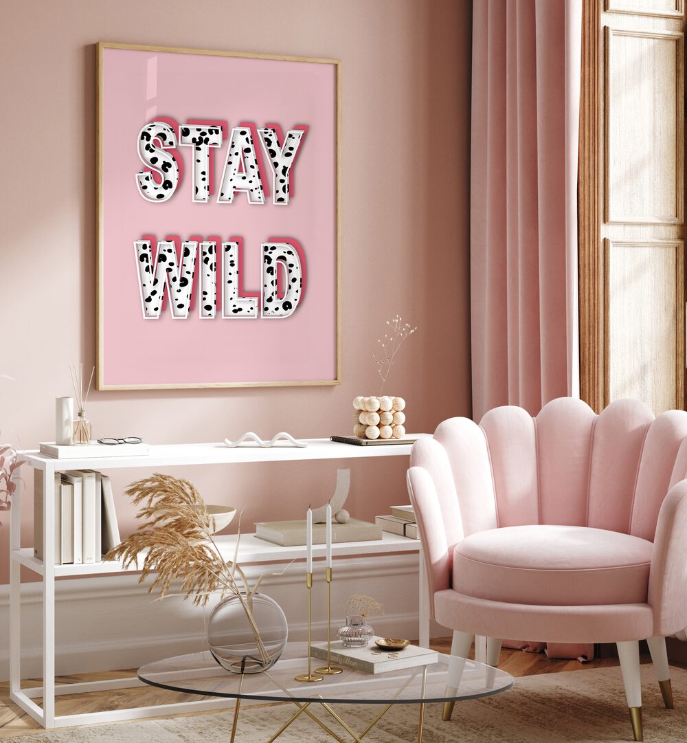 Bright pink wall featuring "STAY WILD, FASHION POSTERS" artwork by Martina, perfect for stylish home decor.