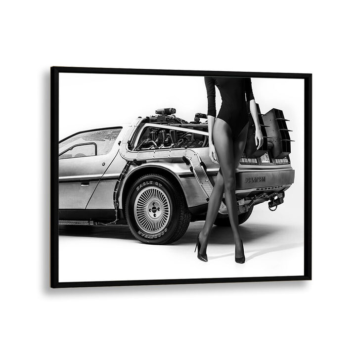 Stylish black-and-white artwork, "THE FUTURE IS FEMALE II, PHOTOGRAPHY PRINTS" by David Drake, featuring a sleek DeLorean.