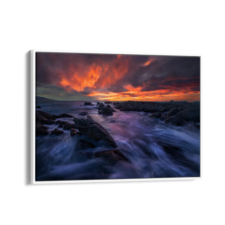Stunning BURNING SKY, PHOTOGRAPHY PRINTS feature vibrant sunset colors over rocky shorelines, perfect for nature lovers.