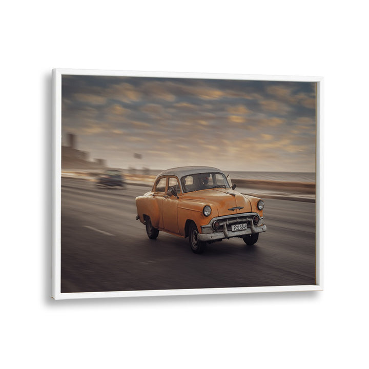 Capture the essence of urban life with MALECON VII, PHOTOGRAPHY PRINTS featuring a vintage car in motion.