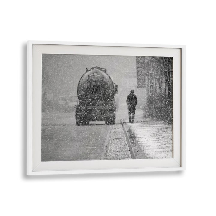 Framed HEAVY THINGS, PHOTOGRAPHY PRINTS showcasing a snowy urban scene with a lone figure and a vintage truck.