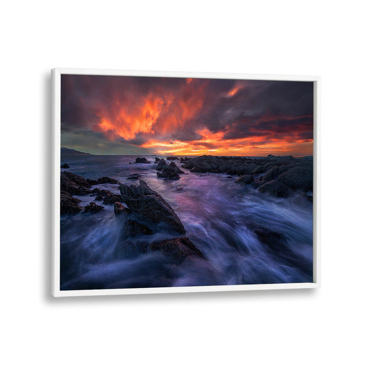 Stunning BURNING SKY, PHOTOGRAPHY PRINTS showcasing a vibrant sunset over rocky shores, perfect for enhancing your space.