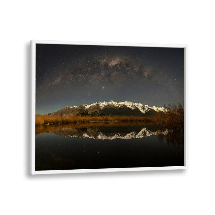 Serene snow mountain under moonlight reflected in calm waters, perfect for photography prints showcasing winter beauty.