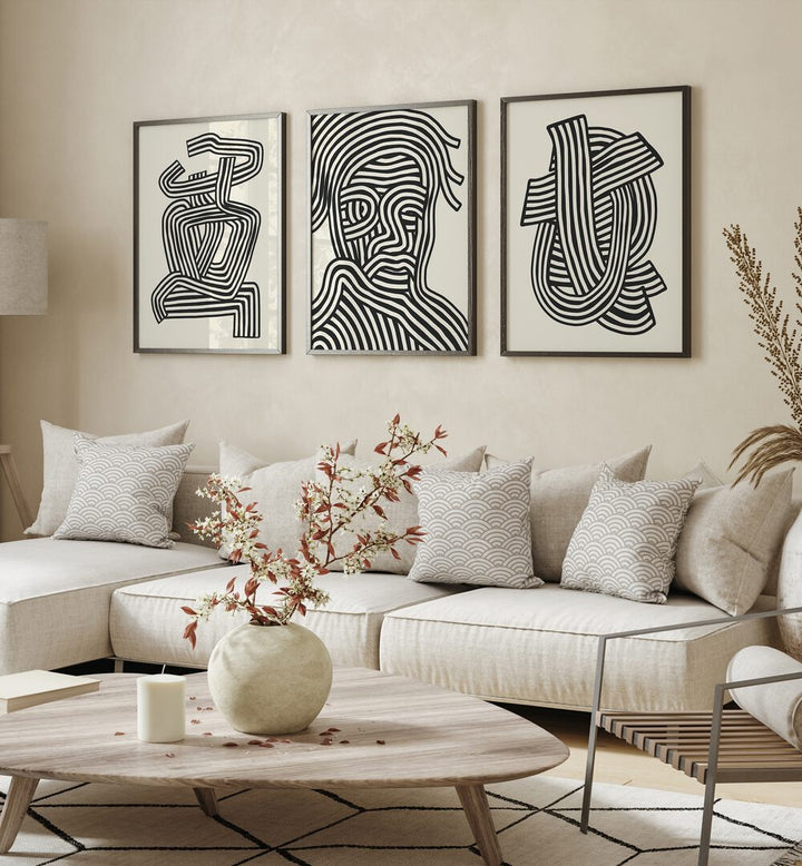 Stylish living room featuring the ABSTRACT LINES INFINITY, SET OF 3 PAINTINGS, enhancing modern decor with elegance.