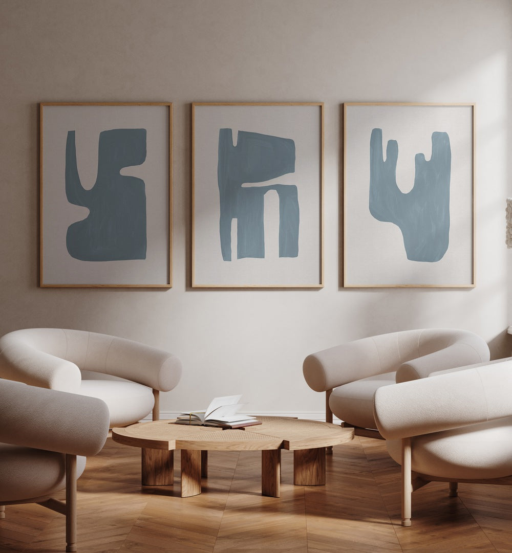 Stylish living room featuring the BLUE GEOMETRICAL ABSTRACT, SET OF 3 PAINTINGS, perfect for modern décor.