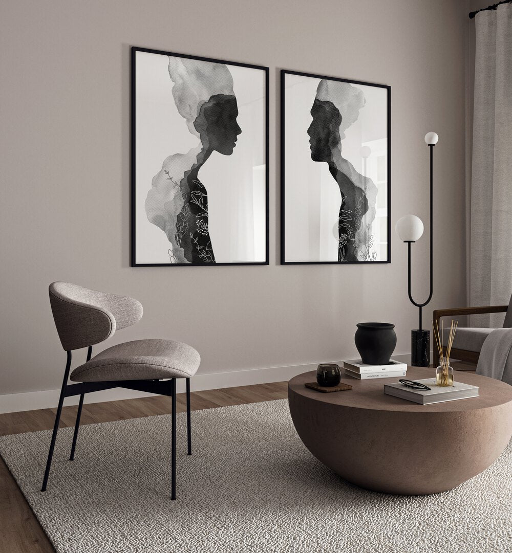 Stylish living room featuring the FACE OFF SET, SET OF 2 PAINTINGS by Asian Monk with striking black-and-white silhouettes.