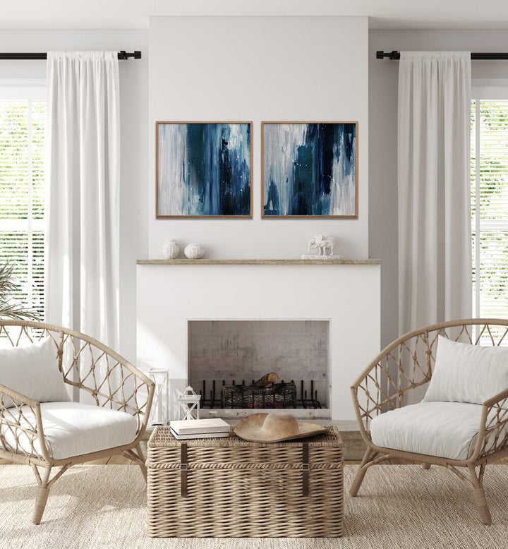 Stylish living room featuring the INDIGO SET, SET OF 2 PAINTINGS in deep blue and gray tones for a serene ambiance.