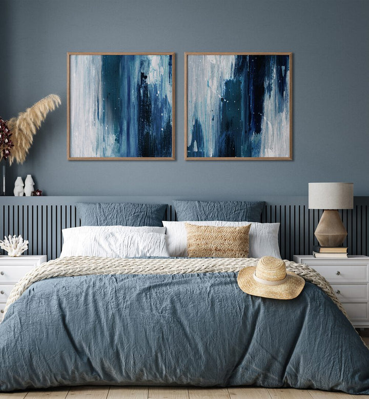 Stylish bedroom featuring the INDIGO SET, SET OF 2 PAINTINGS, showcasing deep blues and gray tones for a serene look.
