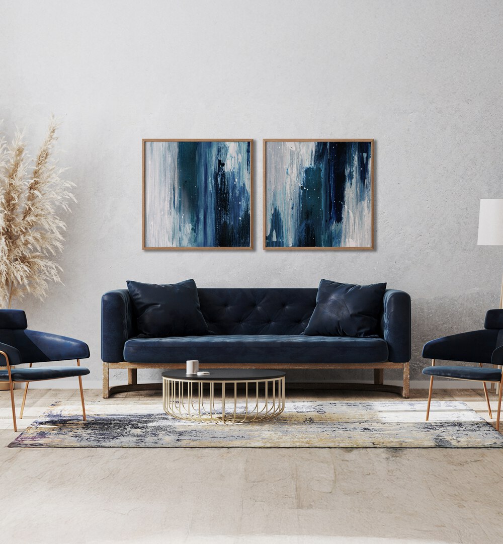 Stylish living room featuring the INDIGO SET, SET OF 2 PAINTINGS in rich blues and soft grays for a serene ambiance.