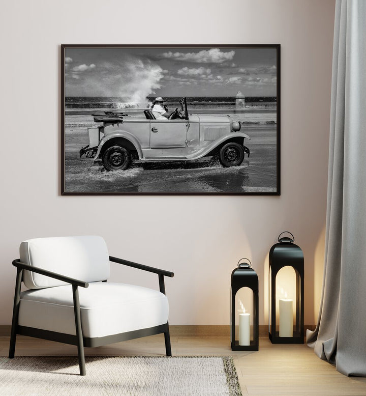 Black and white MALECON, PHOTOGRAPHY PRINTS showcasing a vintage car splashing through the streets of urban life.