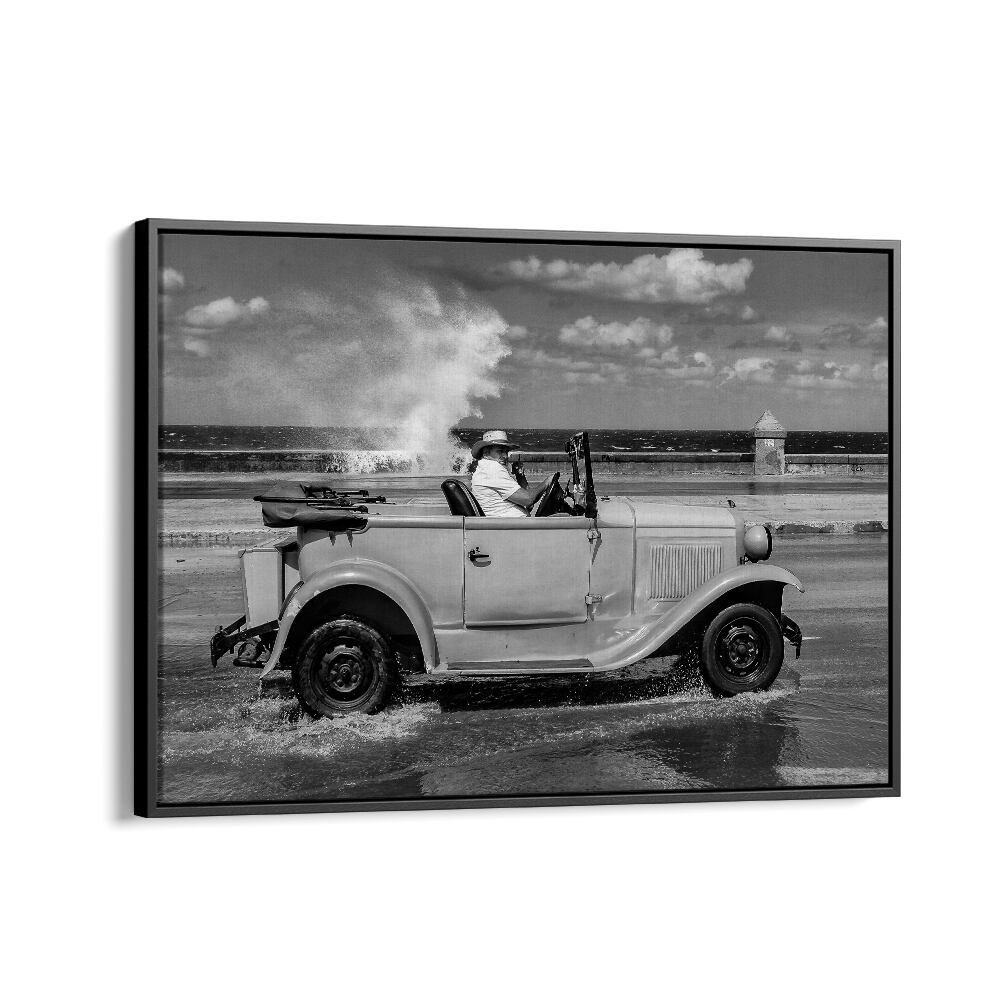 Classic car splashes through Malecon; stunning black-and-white MALECON, PHOTOGRAPHY PRINTS capture urban life moments.