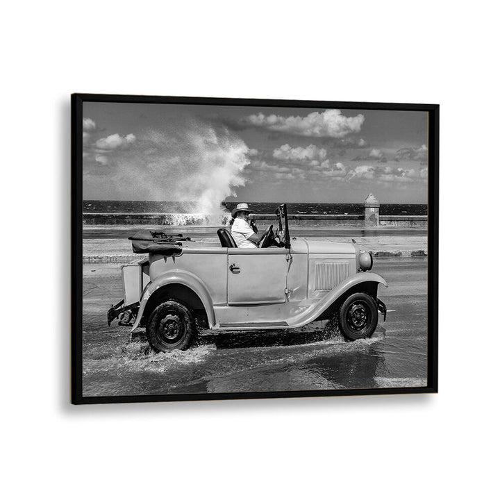 Classic car splashes through waves, showcasing MALECON, PHOTOGRAPHY PRINTS, capturing urban life’s essence.