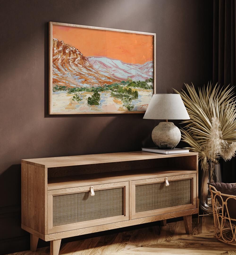 Vibrant MOUNTAIN , LANDSCAPE PAINTINGS showcased above a stylish wooden console in a cozy interior setting.