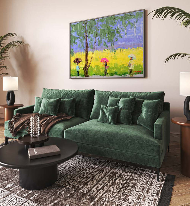 Vibrant RAPE FLOWER RAINY DAY, INDIAN ART PAINTINGS adorns a cozy green sofa, adding color to the living space.
