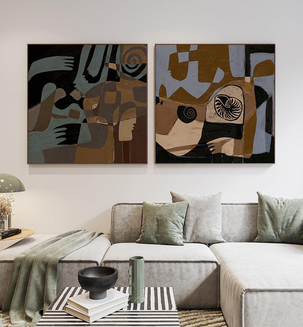 Abstract art pieces on a wall above a sofa with decorative pillows and a coffee table.
