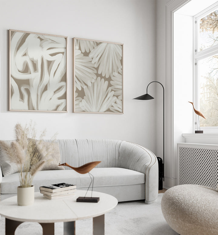 Modern living room with a white sofa, round coffee table, and abstract wall art.