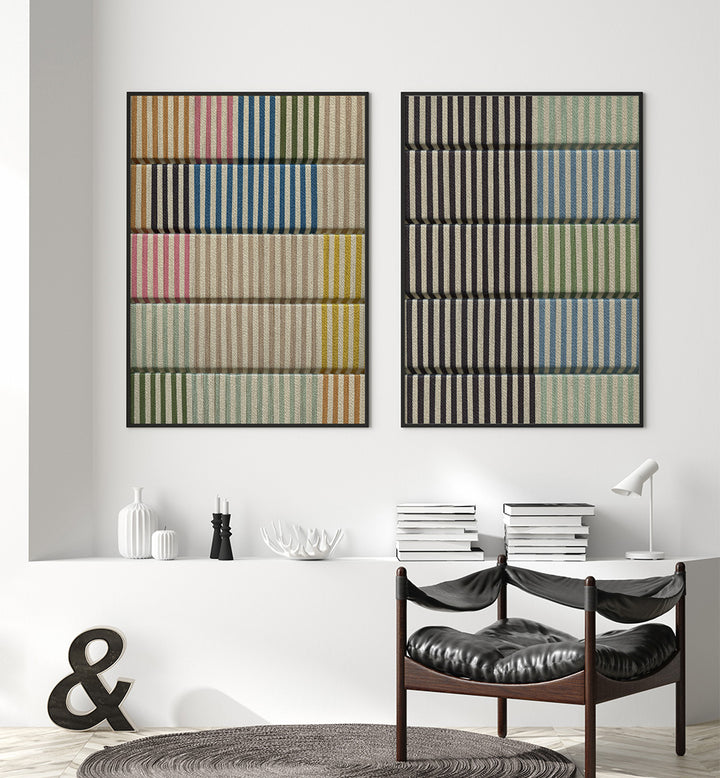 Two abstract art pieces on a wall above a dining table with chairs.