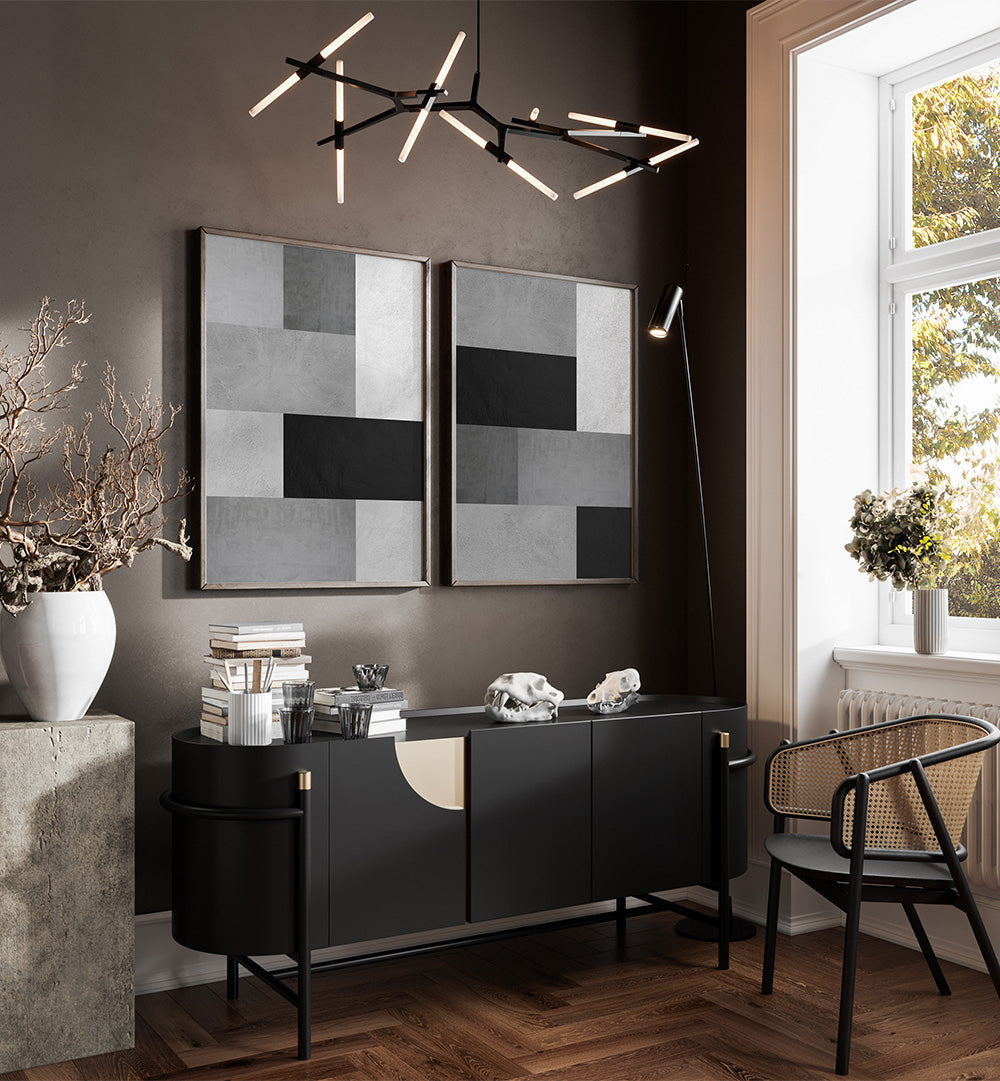 Modern living room with black and white decor, including a chandelier and wall art.