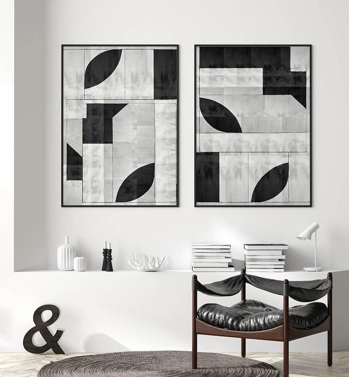 Modern interior with abstract black and white wall art, books, and a chair.