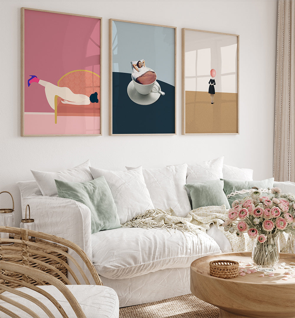 Living room with a white sofa, wicker chair, and three colorful abstract paintings on the wall.