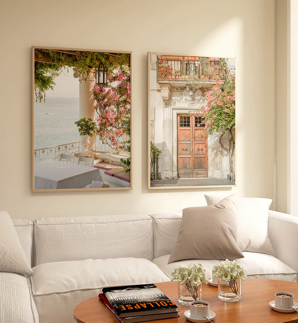 Two framed artworks above a sofa in a living room setting.