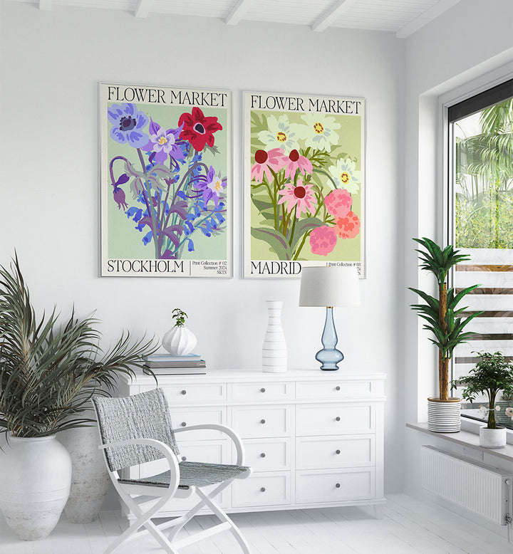 Two floral posters titled 'Flower Market' on a white wall with decorative plants and furniture.