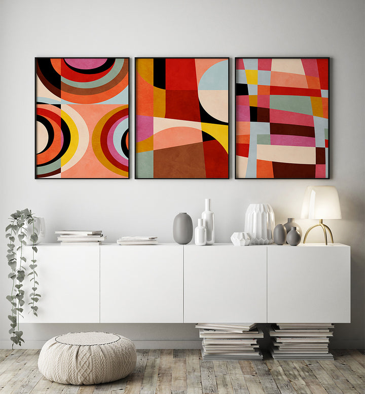 Colorful abstract art on a white wall above a white cabinet with decorative items.