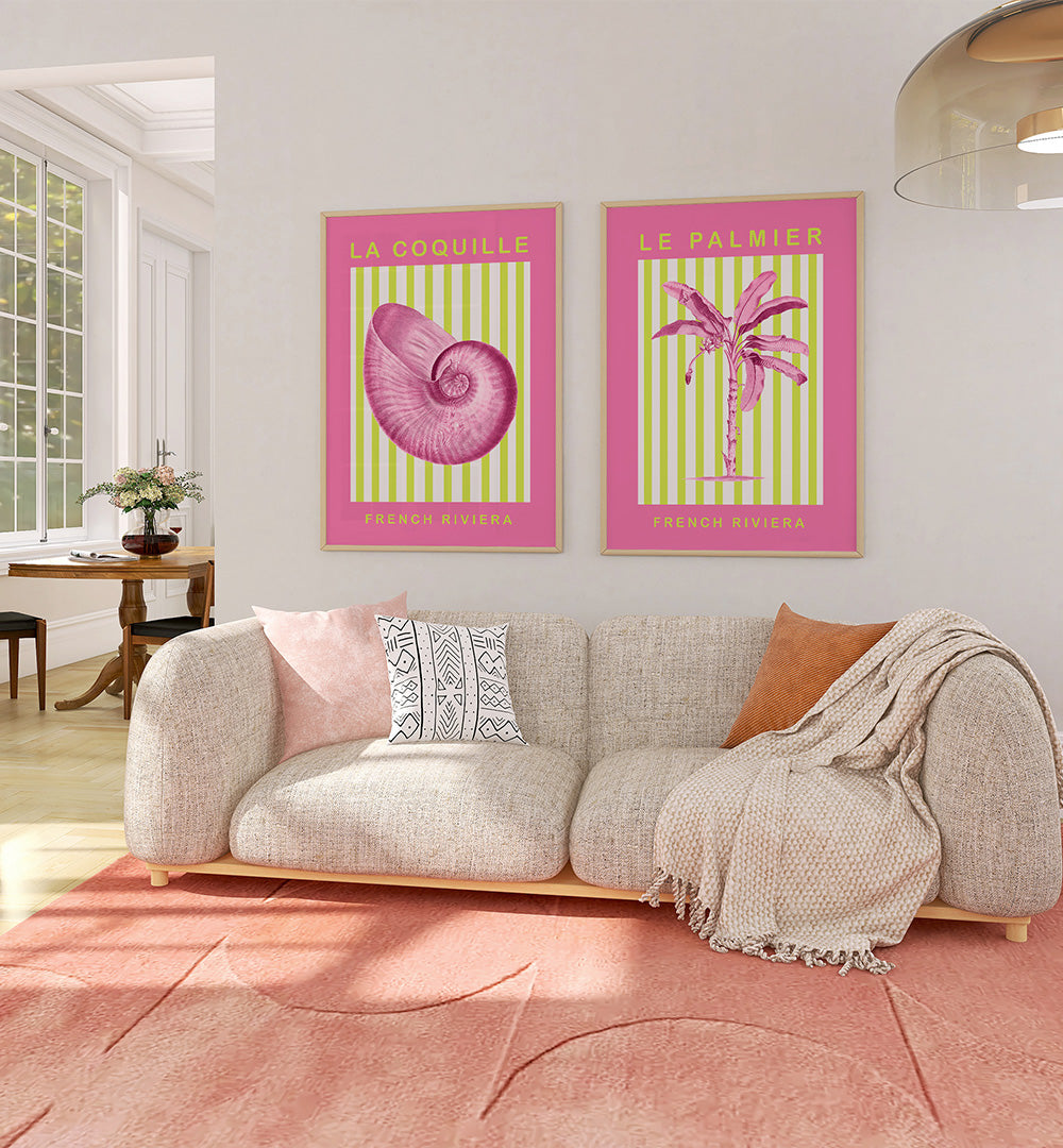 Living room with a sofa, decorative pillows, and two framed posters on the wall.