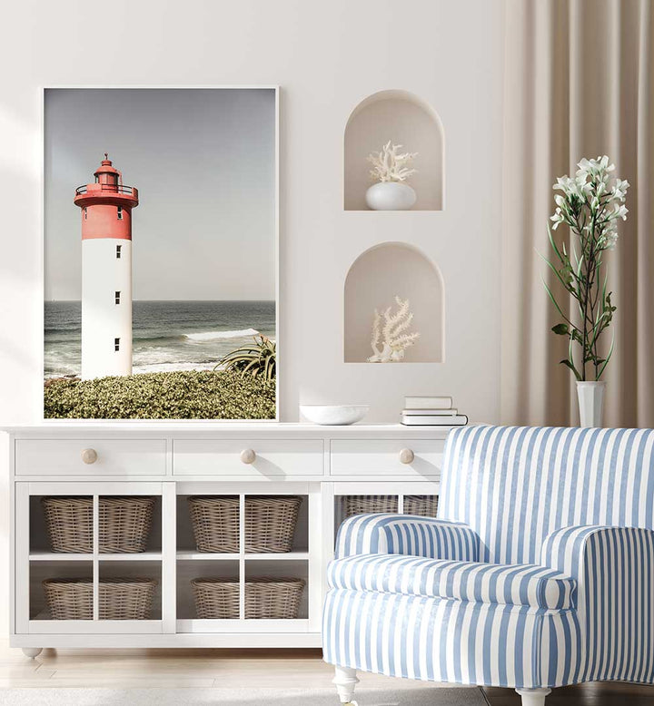 BEACON BY THE SEA , BEACH PAINTINGS framed lighthouse print above white console in coastal living room vignette