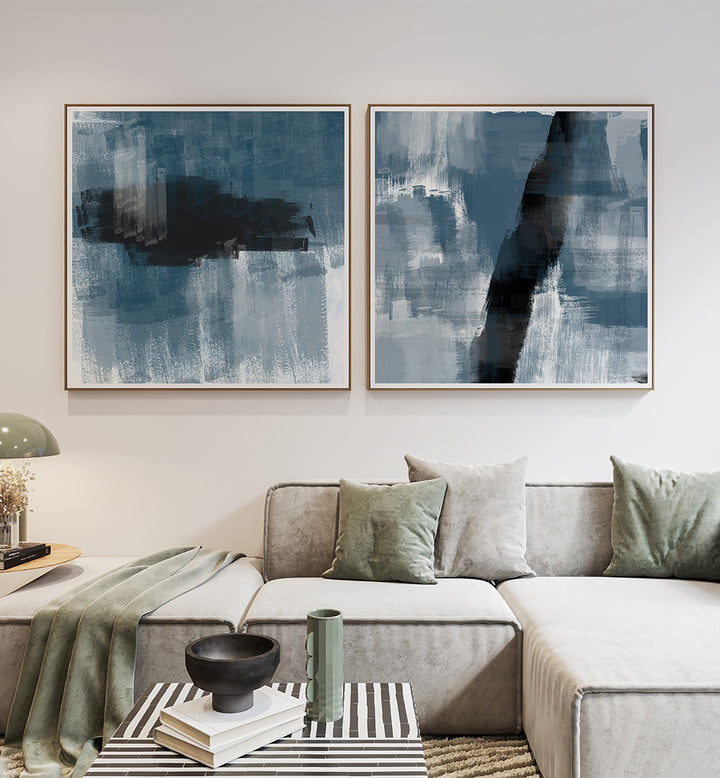 Modern living room with abstract blue artworks on the wall and a gray sofa.