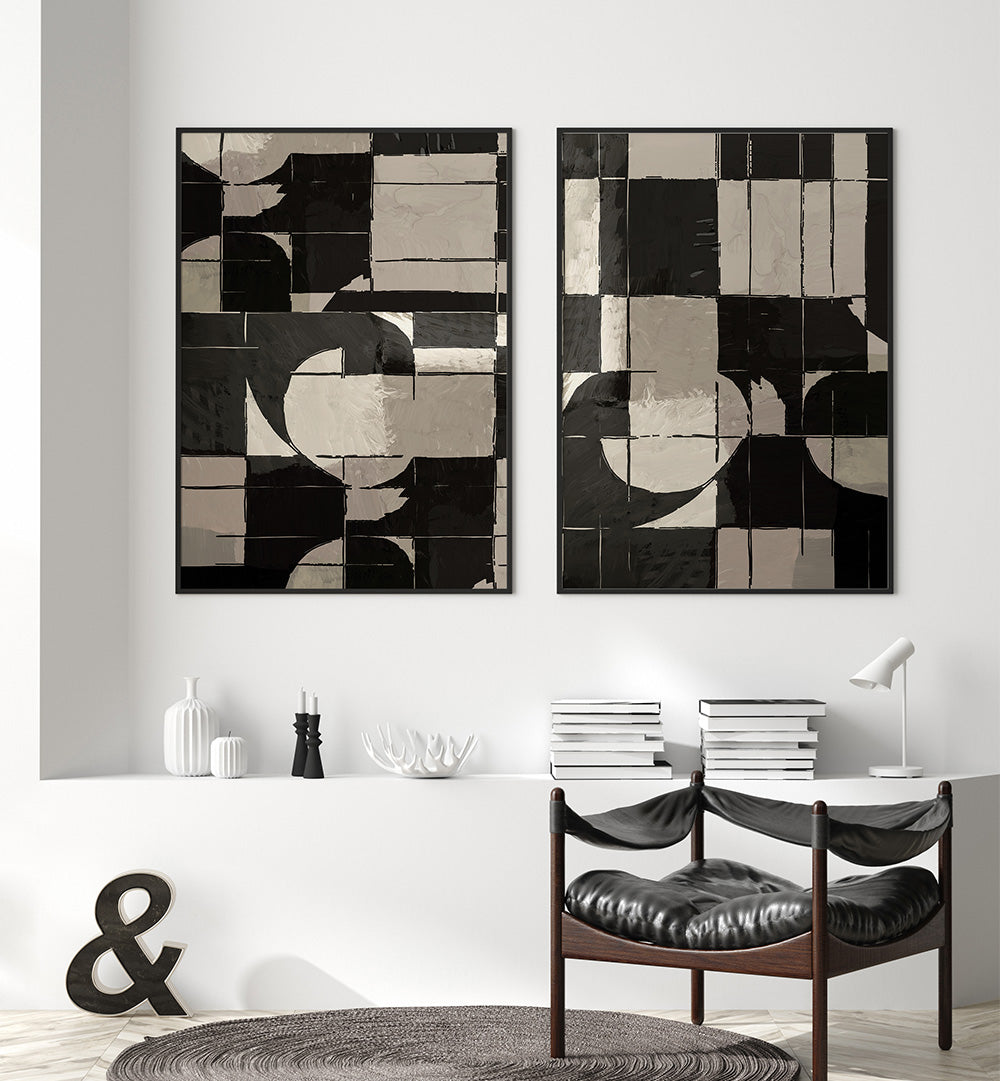 Two abstract art pieces on a wall above a dining table with chairs.