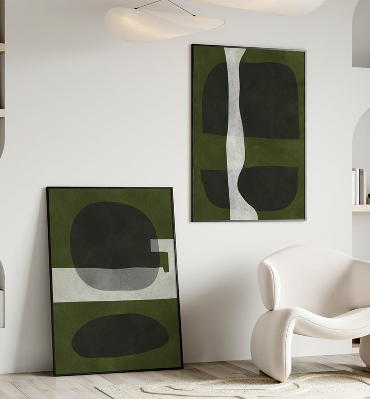 Modern interior with abstract green and black artworks on a white wall.
