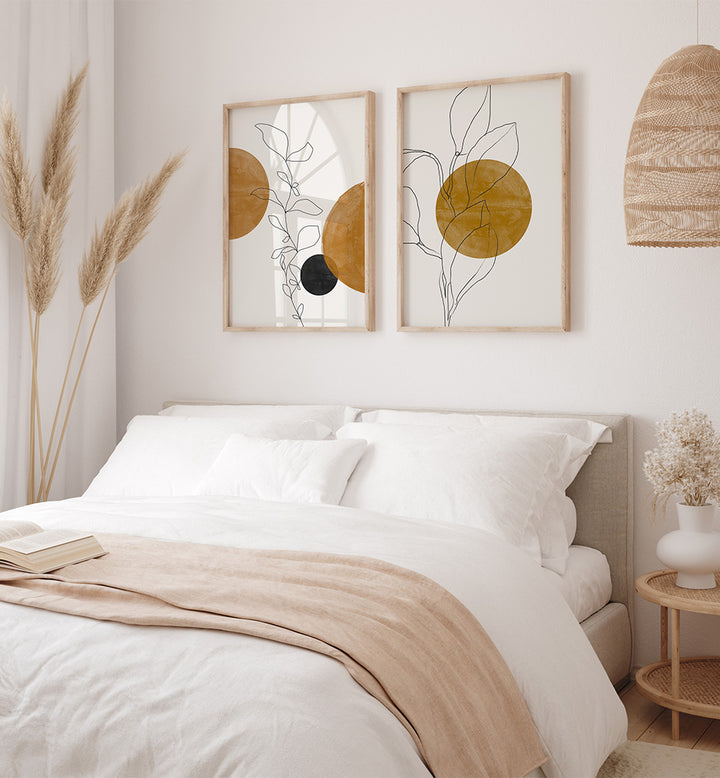 Neatly made bed with beige blanket in a bedroom with wall art and decor.