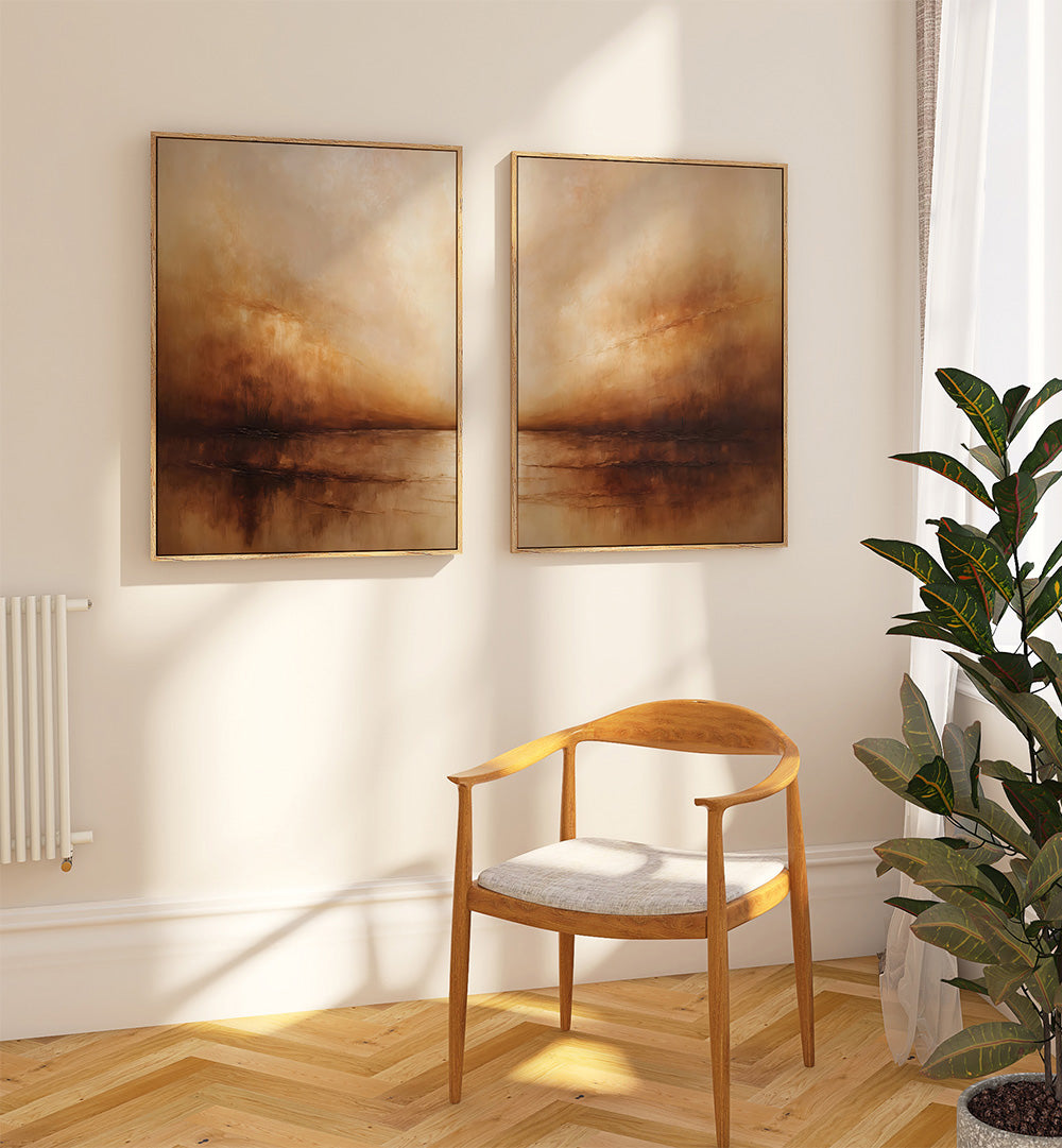 Two abstract paintings on a wall above a wooden chair with a plant to the side.