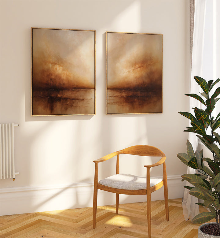 Two abstract paintings on a wall above a wooden chair with a plant to the side.