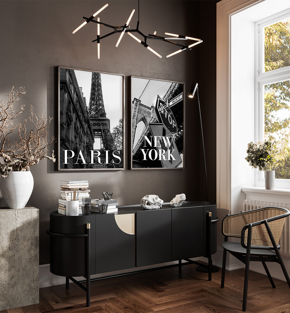 Modern interior with black and white decor, including a sideboard and framed pictures of Paris and New York.