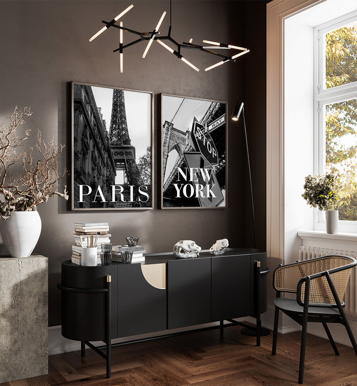 Modern interior with black and white decor, including a sideboard and framed pictures of Paris and New York.