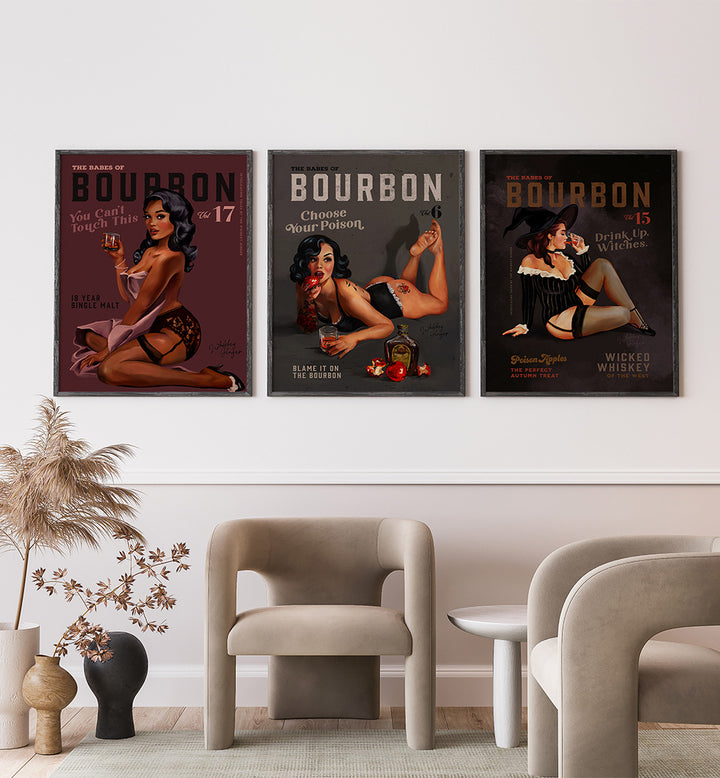 Three vintage-style Bourbon posters on a wall above modern furniture.