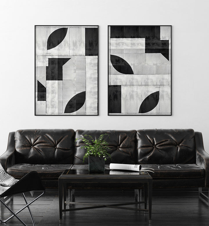 Modern living room with black leather sofa and abstract wall art