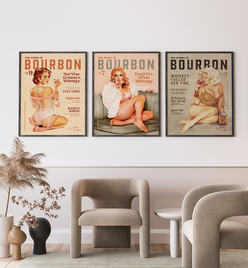 Three vintage-style bourbon posters on a wall above modern furniture.