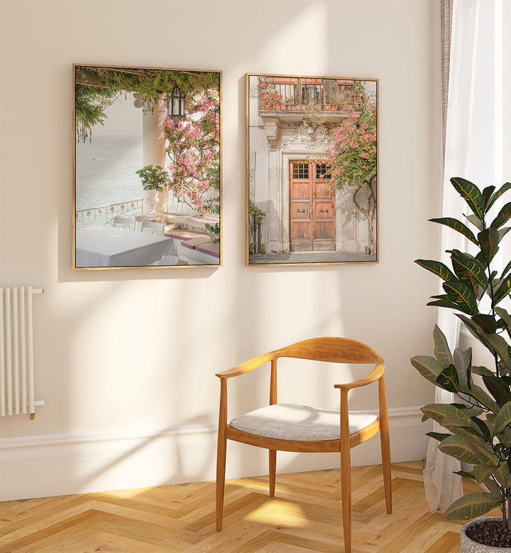 Wooden chair with a cushion in a room with two framed pictures on the wall and a plant.