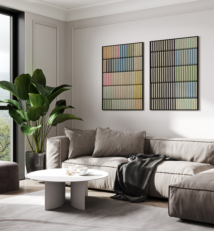 Modern living room with a gray sectional sofa, white coffee table, and abstract wall art.