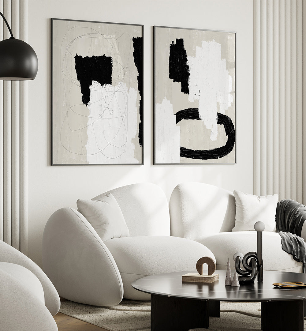Modern living room with abstract art, white sofa, and black coffee table.