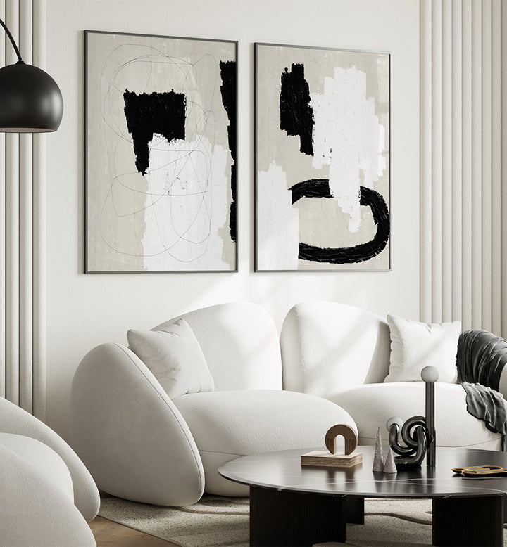 Modern living room with abstract art, white sofa, and black coffee table.