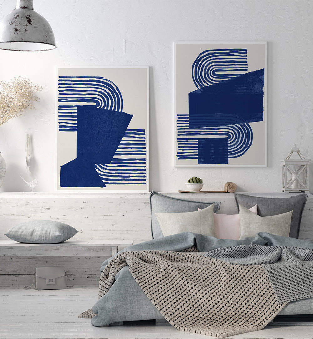 Modern bedroom with abstract blue and white wall art, gray bedding, and a white bed frame.